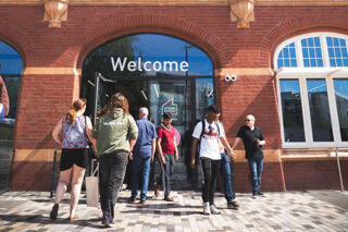 Students walking into the steamhouse building
