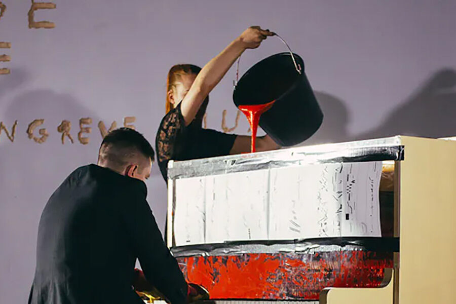 Experimental performance - piano playing with red paint poured in
