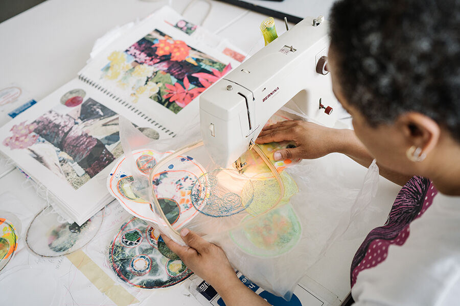 Woman using a sewing machine - view from above