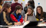 Students sat round table working together