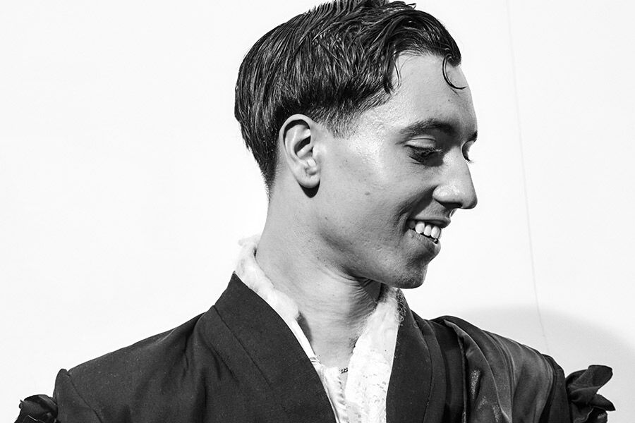Black and white photo of a student's side profile, smiling