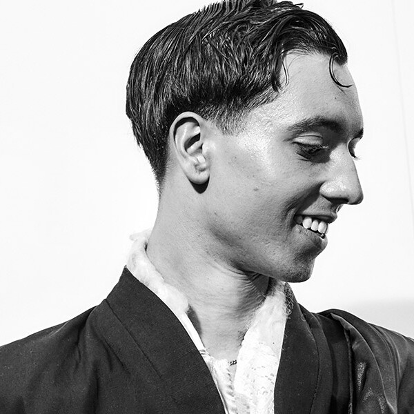 Black and white photo of a student's side profile, smiling