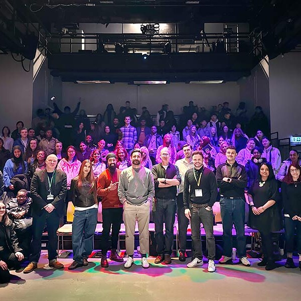 MA Future Media students and lecturers stood in large room at a convention