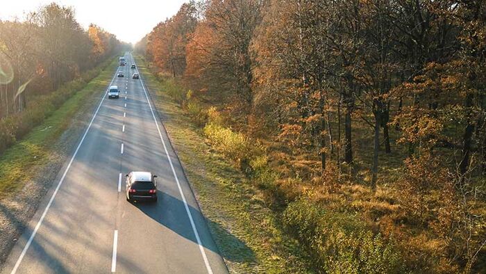 Aerial shot of cars driving on countryside road