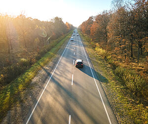 Aerial shot of cars driving on countryside road