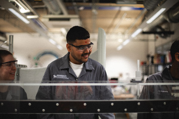Three students in an engineering lab