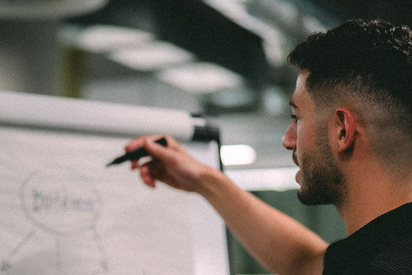 A student writes on a whiteboard