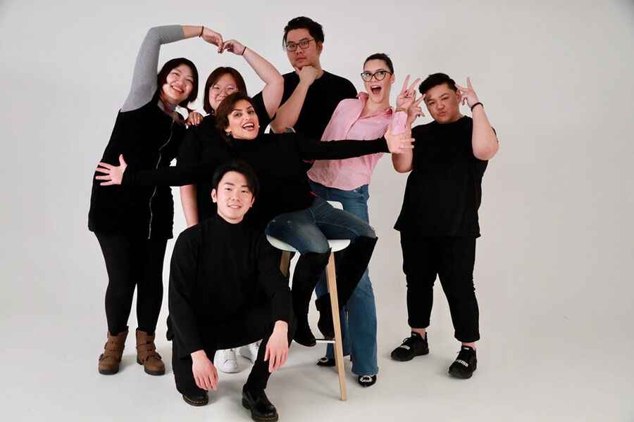 MA Future Media students posing in different positions against a white background