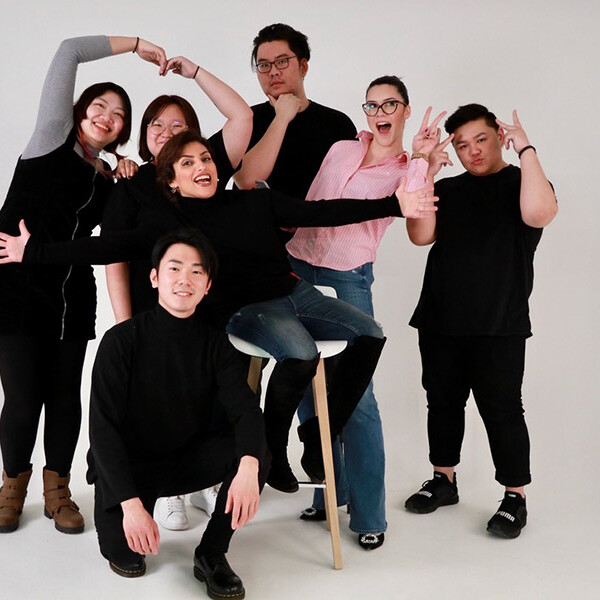 MA Future Media students posing in different positions against a white background