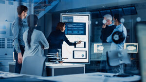 Photo of people around a smart whiteboard