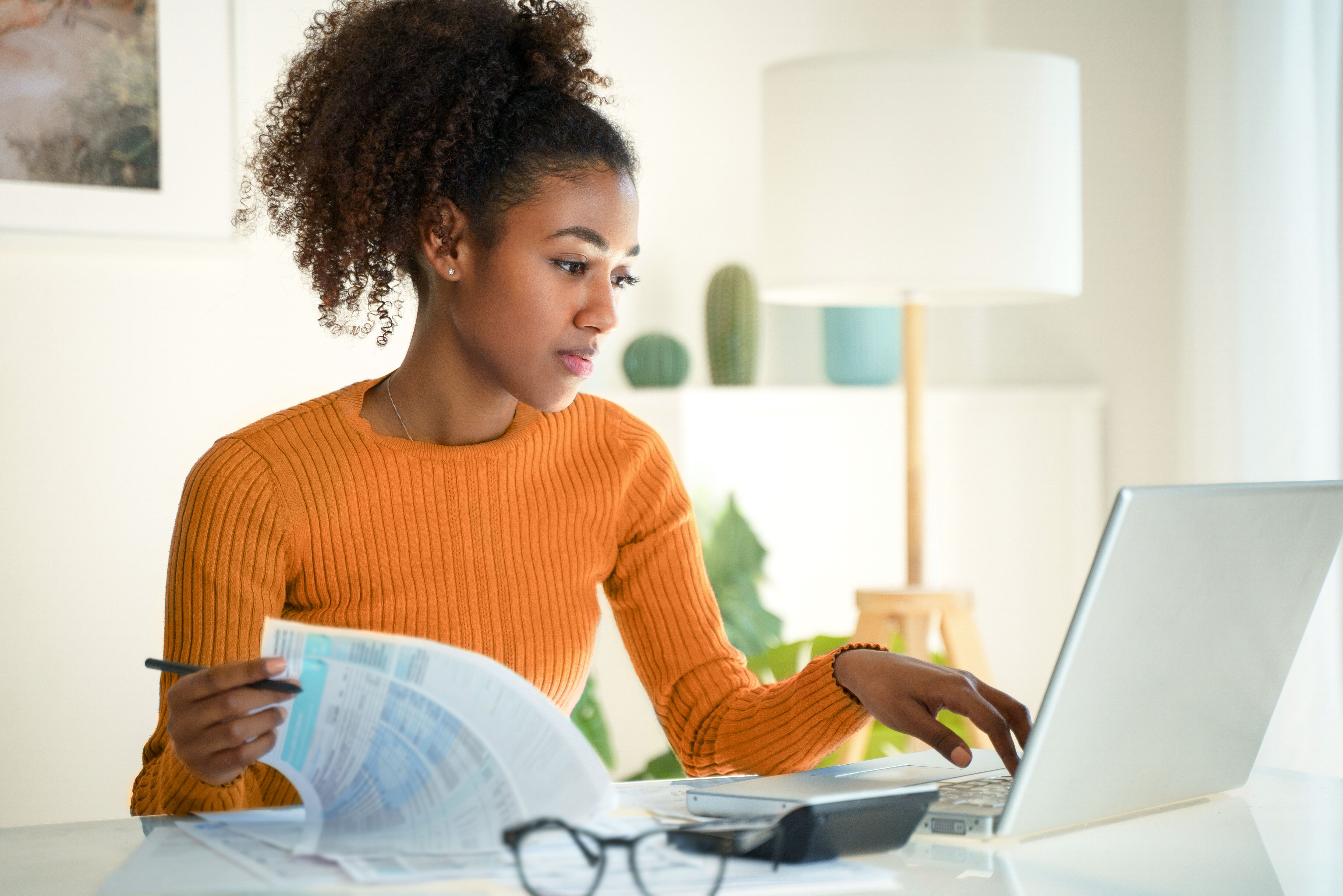 Student in front of computer and papers at home