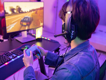 Person playing a video game with headset