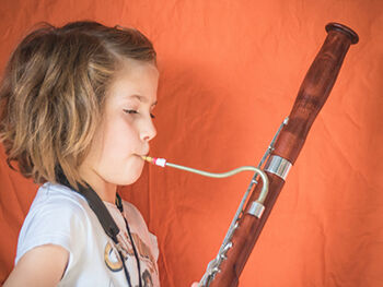 A child playing a bassoon.
