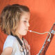 A child playing a bassoon.