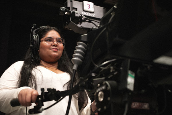 A student operates a film camera