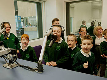Taking to the airwaves ... pupils from Hazel Oak School Children recording a podcast around the microphones in Birmingham City University's radio studios