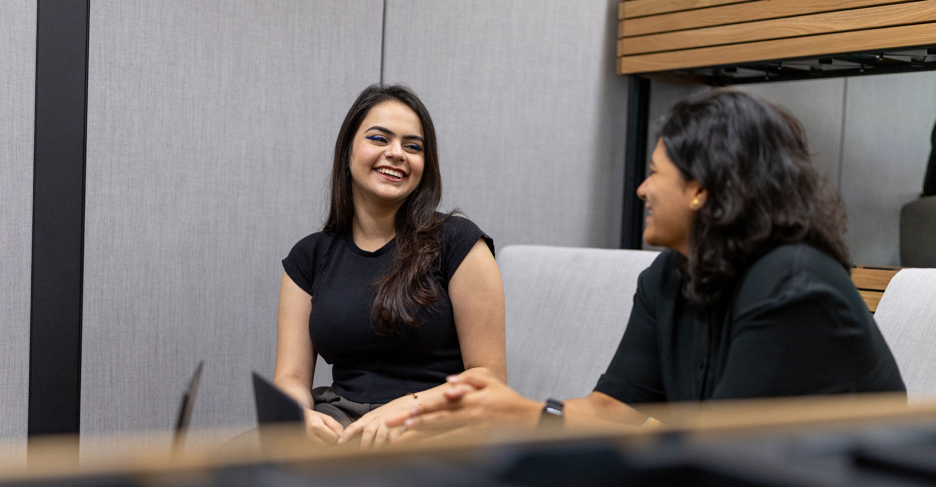 Two students talking in a study space in the STEAMhouse building
