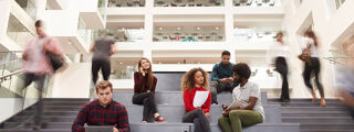 Higher education students studying in foyer