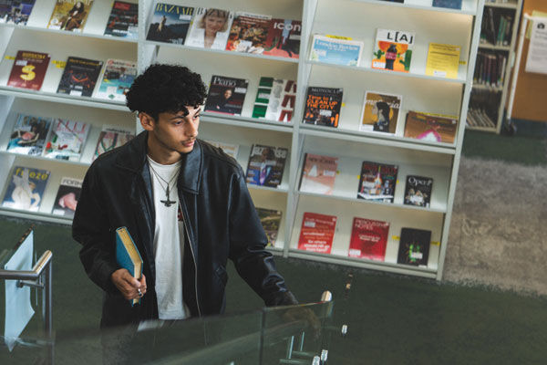 A student walks up the stairs in the library