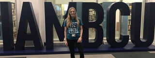 I AM BCU Article 1200x450 - Student in front of I AM BCU letters