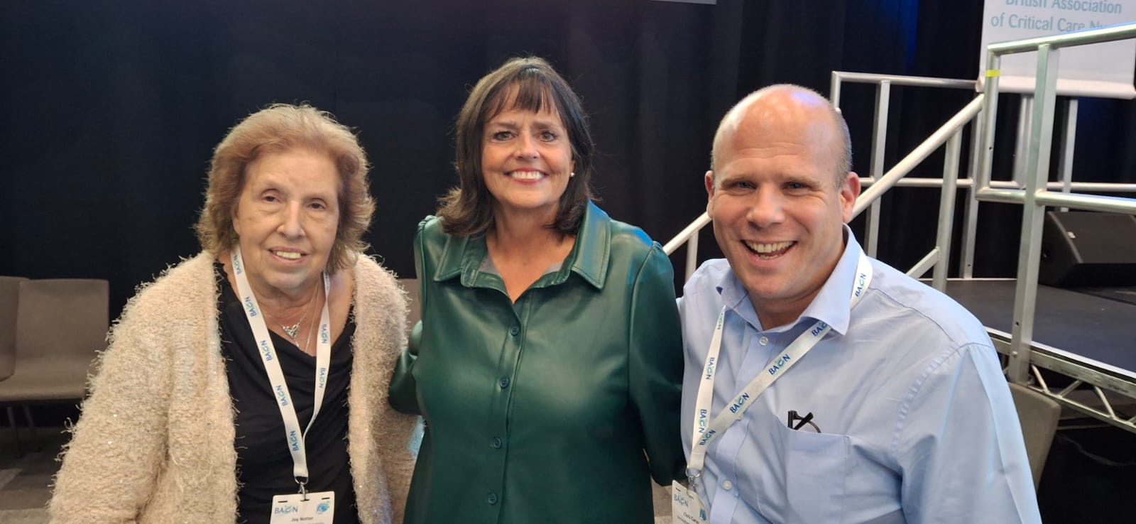 Three nurses stood together smiling