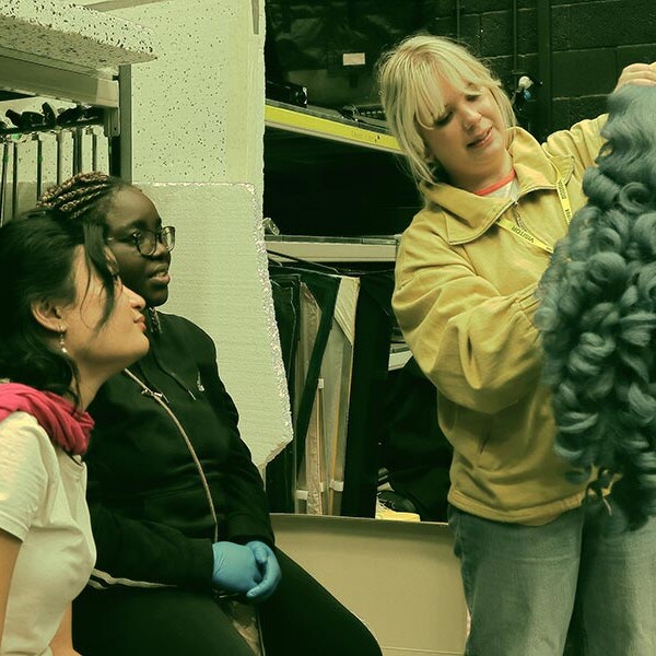 Students using a wig for costume purposes