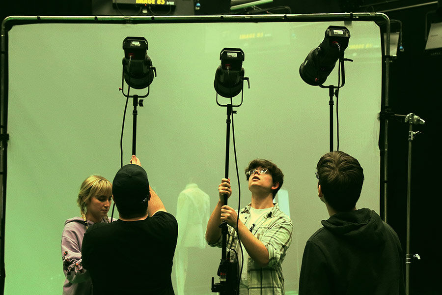 Students setting up studio lights