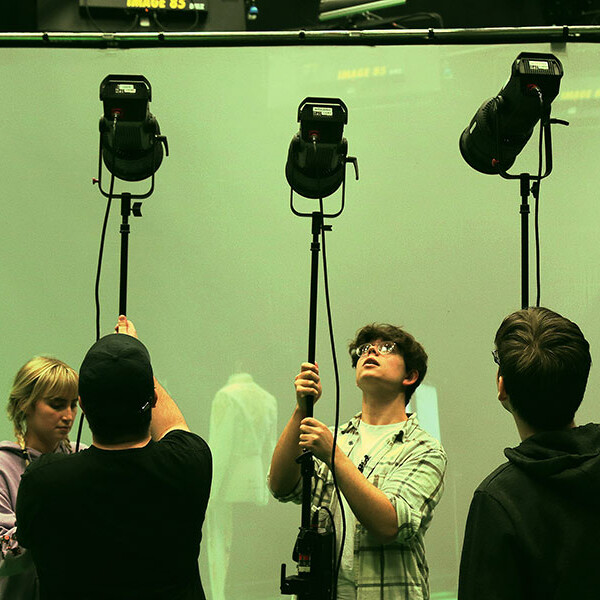 Students setting up studio lights
