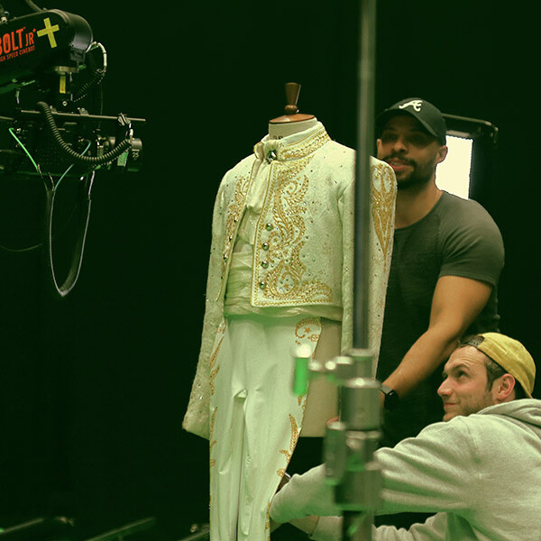 Students stood behind costume for camera shoot