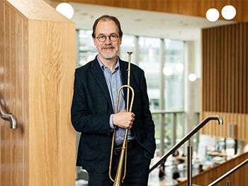 Jamie Savan holding musical instrument