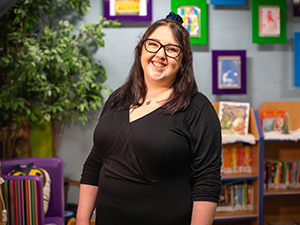 Education Studies student, Jessica Warne, stands posing for her I AM BCU photo at Annie Lennard Primary School