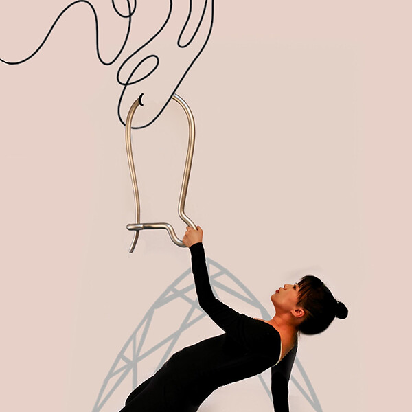 A student holding onto a large silver earring.