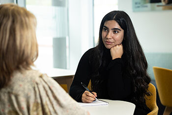 Law Clinic interview, discussion Two people sitting in the law clinic having a discussion