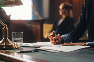 Lawyer signing papers