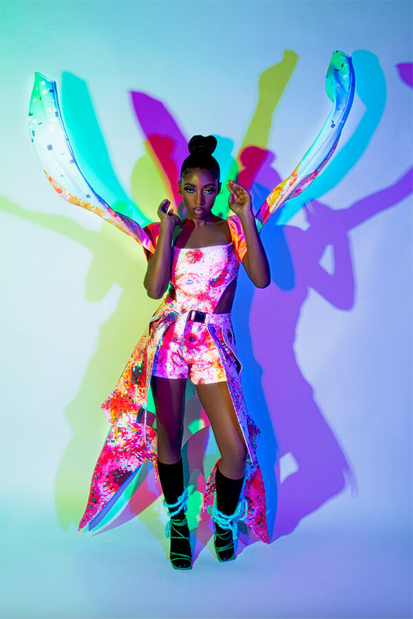 Model in butterfly style clothes in coloured light