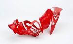 A red shoe made of plastic curves