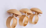Three rings with round caps attached to the top