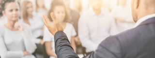 Management PG Careers 1200x450 - Man talking to a crowd