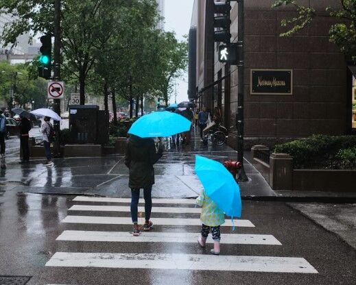 Mothers and chlld with blue umbrellas