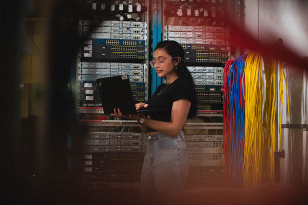 A student uses their laptop in a computer networks lab