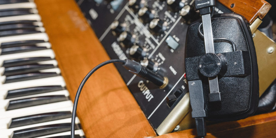 (L-R) Martin Smith, Dave Scott-Morgan, Stephen Maddock Headphones plugged into a synthesizer or electronic musical instrument.