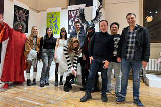 students in headdresses in art gallery