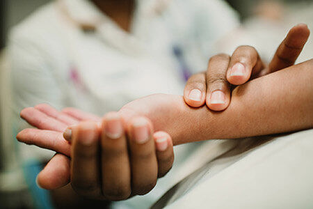 Nurse measuring a patient's pulse