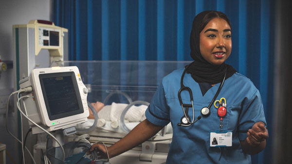 A nursing student talking to someone oof camera