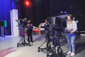 Students using film cameras in film studio