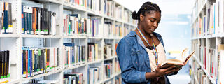 Student reading a book in the library