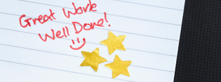 Piece of paper with the words great work, well done and 3 gold stars
