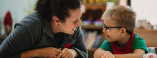 Student working with young child