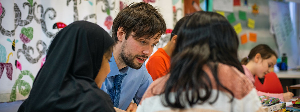 Teacher with primary school students in classroom