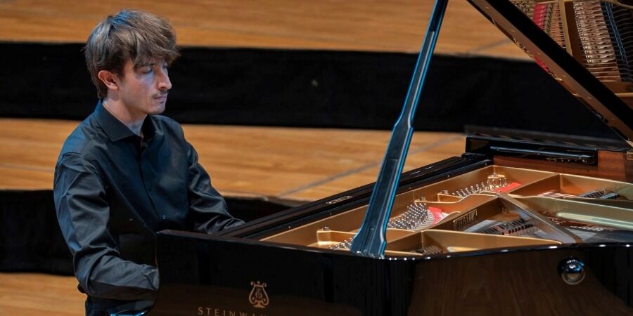 Max Walsh playing the piano